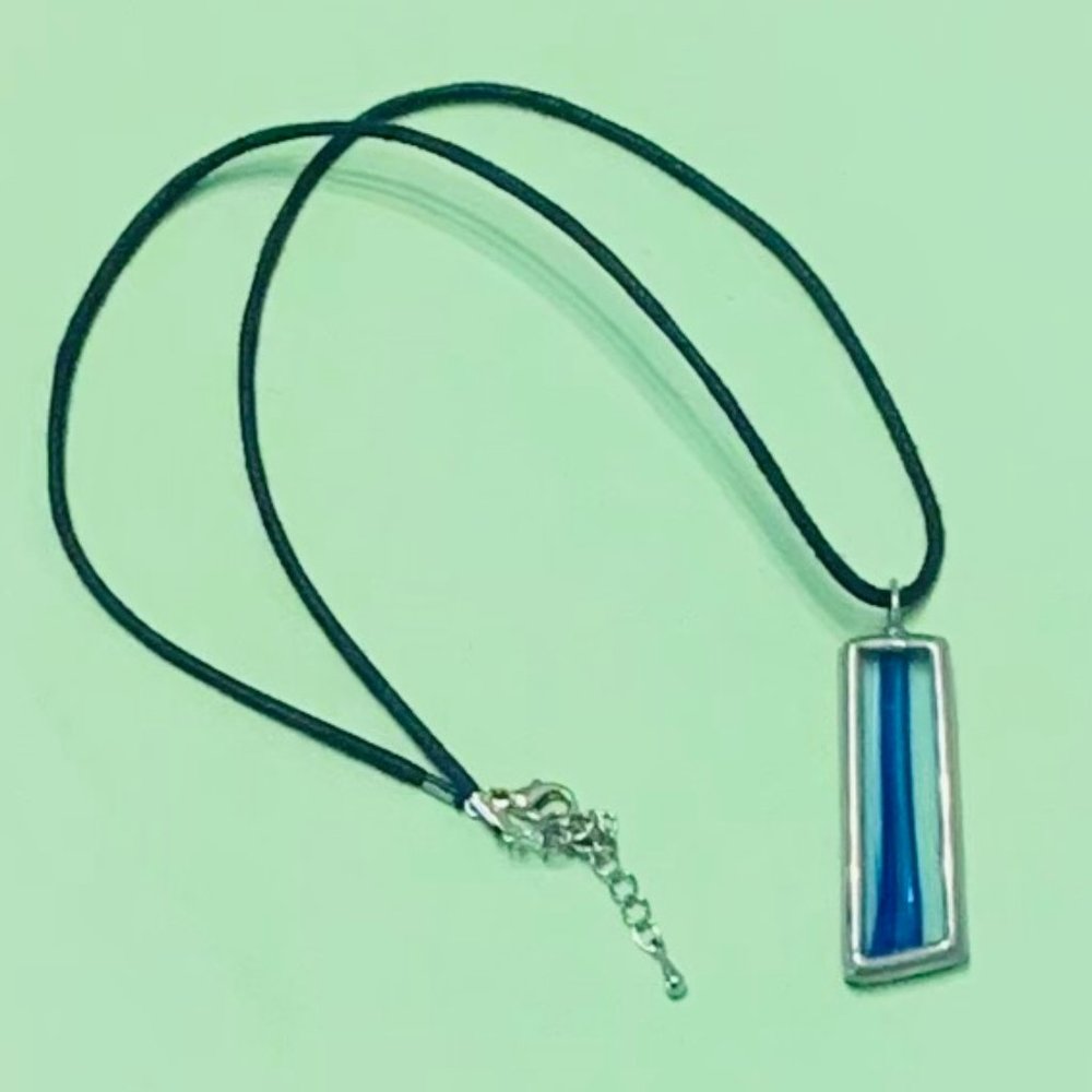 Blue stained glass pendant on black rope necklace